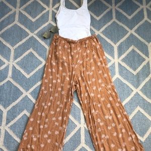 Orange flowy pants.
